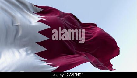 Detail of the Qatar national flag fluttering. The flag is maroon with a wide white wedge-shaped band. 3D illustration render. Close-up. Rippling fabri Stock Photo