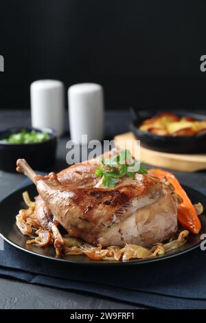 Tasty cooked rabbit meat with vegetables served on table Stock Photo