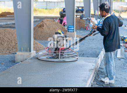 Concrete floor grinding machine is an essential tool used to prepare the surface of a concrete floor in car park. Stock Photo