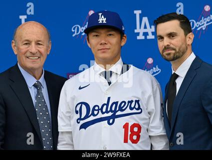 Los Angeles, United States. 27th Dec, 2023. Japanese pitcher Yoshinobu Yamamoto, wears his number 18 jersey as he poses with Executive Vice President and General Manager Brandon Gomes (R) and team president Stan Kasten (L) during his introductory press conference at Dodger Stadium in Los Angeles on Wednesday, December 27, 2023. Photo by Jim Ruymen/UPI Credit: UPI/Alamy Live News Stock Photo