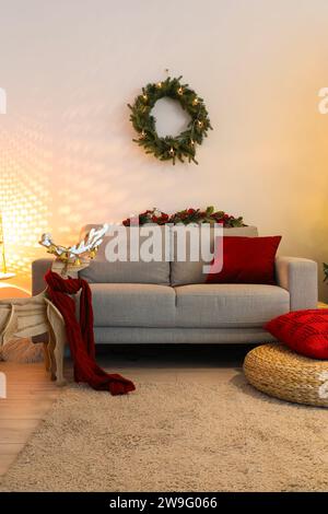 Interior of living room with Christmas wreath, sofa and reindeer Stock Photo