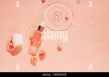 Moisturising cosmetics on pastel peach coloured background of water, waves Stock Photo