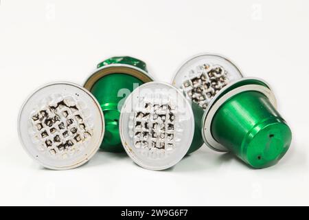 Green used plastic Espresso coffee pods single use cups, isolated on a white background with copy space. Stock Photo