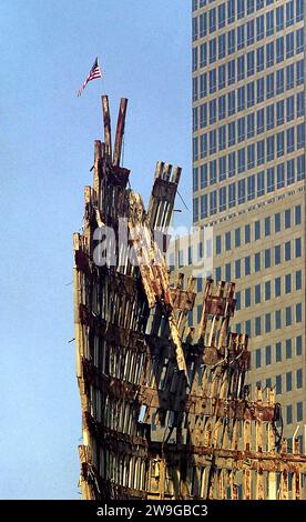 File photo dated 23/9/2001 of a US flag flies from the remains of the World Trade Centre. Civil servants were warned that the allocation of EU funds to ex-prisoner groups in Northern Ireland was to come under intensified scrutiny from Brussels in the wake of 9/11. Officials were told of inevitably heightened sensitivities within the European Commission on how its Peace Programme funding initiative would be portrayed internationally, after the terror attack on the US, according to a newly released archive document from the Public Records Office of Northern Ireland. Issue date: Thursday December Stock Photo