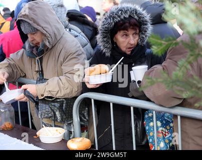 Krakow, Poland - Dec 17, 2023: Christmas Eve for poor and homeless on the Main Square in Cracow. The group Kosciuszko prepares the greatest eve in the Stock Photo