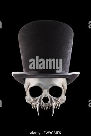 Vampire skull with extra tall black vintage top hat isolated on black background Stock Photo