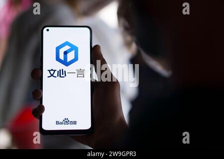 Dhaka, Bangladesh - 27 December 2023: Hand holding a phone with Ernie bot AI chatbot. Ernie Bot full name Enhanced Representation through Knowledge In Stock Photo