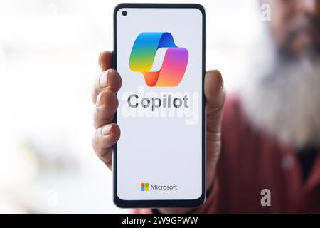Dhaka, Bangladesh - 27 December 2023: Hand holding a phone with Microsoft Copilot AI chatbot. Microsoft Copilot is a chatbot developed by Microsoft. Stock Photo
