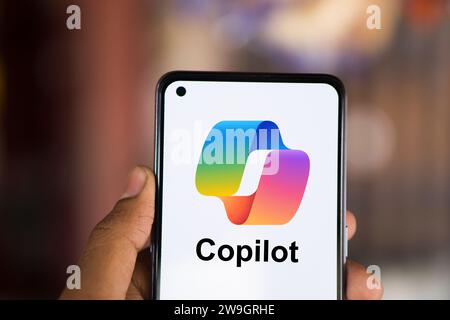 Dhaka, Bangladesh - 27 December 2023: Hand holding a phone with Microsoft Copilot AI chatbot. Microsoft Copilot is a chatbot developed by Microsoft. Stock Photo