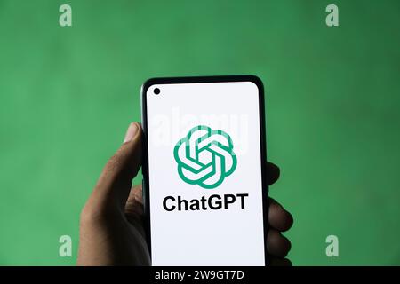 Dhaka, Bangladesh - 27 December 2023: Hand holding a phone with ChatGPT AI chatbot. ChatGPT is a chatbot developed by OpenAI. Stock Photo