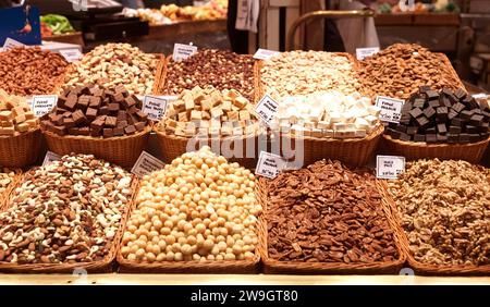 Variety of nuts and dried fruits on the counter in the market Stock Photo