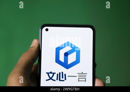 Dhaka, Bangladesh - 27 December 2023: Hand holding a phone with Ernie bot AI chatbot. Stock Photo