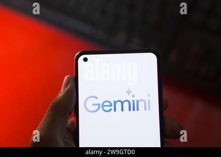 Dhaka, Bangladesh - 27 December 2023: Hand holding a phone with Google Gemini AI chatbot Gemini is a family of multimodal large language models develo Stock Photo