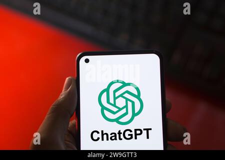 Dhaka, Bangladesh - 27 December 2023: Hand holding a phone with ChatGPT AI chatbot. ChatGPT is a chatbot developed by OpenAI. Stock Photo