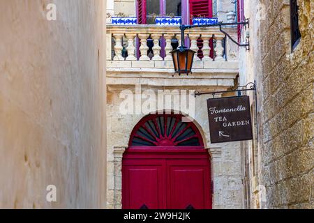 A line of houses with brick and timber walls and roofs in blue, orange ...