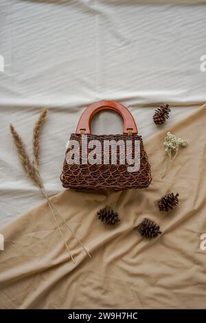 Woven Bag, Traditional Handmade Brown Square Woven Bag on a White and Brown Background. Stock Photo