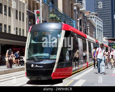 View of passengers leaving a tram stopped at the Circular Quay tram stop in Sydney Australia on a bright sunny spring day in November Stock Photo