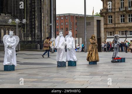 COLOGNE, GERMANY - MAY 16, 2013: These are unidentified street performers in fabulous outfits on Cathedral Square. Stock Photo
