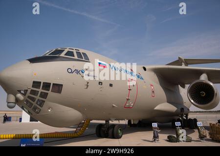 Russian military transport plane, Ilyushine Il-76MD-90A, on display at the Dubai Airshow, with military equipment on the ground. Stock Photo