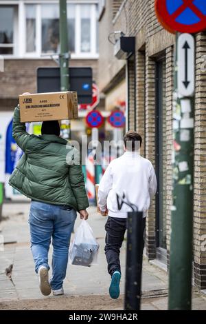 BAARLE-NASSAU - Customers leave a fireworks store in Baarle-Nassau, Belgium, with their purchases. Now that the sale of fireworks has started in the Netherlands, they can also cross the Dutch border. ANP ROB ENGELAAR netherlands out - belgium out Stock Photo