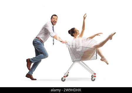 Man running and pushing a ballerina in a shopping cart isolated on white background Stock Photo