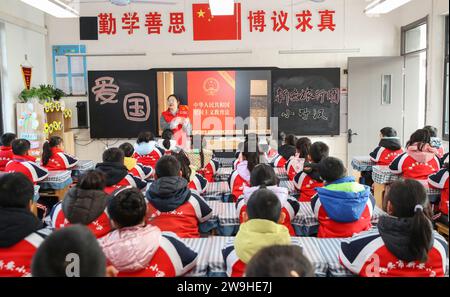 HUAI'AN, CHINA - DECEMBER 28, 2023 - A volunteer lawyer explains the Patriotic Education Law of the People's Republic of China to primary school stude Stock Photo