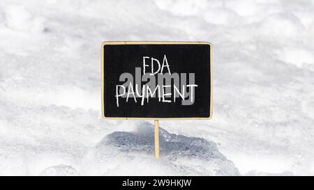 FDA Food and Drug Administration payment symbol. Concept words FDA payment on beautiful black chalk blackboard. Beautiful white snow background. Busin Stock Photo