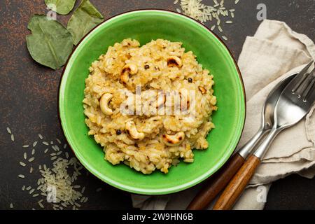 Ven Pongal (Khara Pongal), traditional Indian savoury rice dish made during celebrating Pongal festival, served in bowl top view on concrete rustic Stock Photo