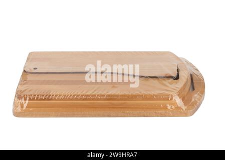 Kitchen set of cutting boards and a kitchen spatula, packed in polyethylene, on a white background. Copy space. Stock Photo