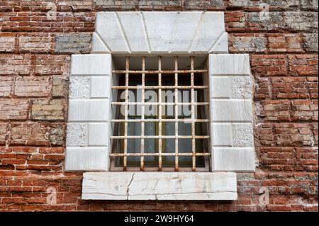 Iron bars on an old stone window in Venice Stock Photo