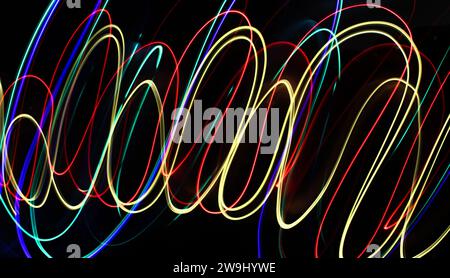 A photograph of vibrant multi-color lights in a long exposure photo. Light painting photography Stock Photo