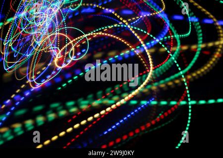 A photograph of vibrant multi-color lights in a long exposure photo. Dotted lines pattern, waves of colour. Light painting photography Stock Photo