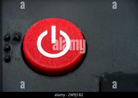 Red power button of a TV remote, close up macro. Stock Photo