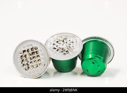 Green used plastic Espresso coffee pods single use cups, isolated on a white background with copy space. Stock Photo