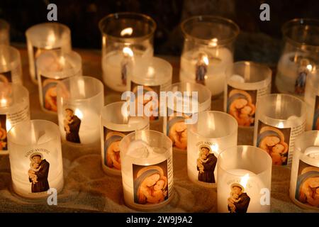 Prayer candles bearing the image of Mary, baby Jesus and Saint-Antoine on Boxing Day in the Notre-Dame de Tulle Catholic Cathedral in Corrèze. Tulle, Stock Photo