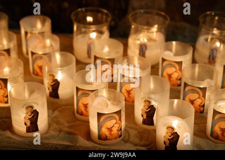 Prayer candles bearing the image of Mary, baby Jesus and Saint-Antoine on Boxing Day in the Notre-Dame de Tulle Catholic Cathedral in Corrèze. Tulle, Stock Photo