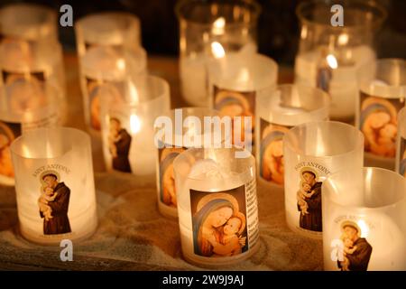 Prayer candles bearing the image of Mary, baby Jesus and Saint-Antoine on Boxing Day in the Notre-Dame de Tulle Catholic Cathedral in Corrèze. Tulle, Stock Photo