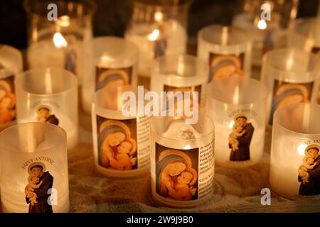 Prayer candles bearing the image of Mary, baby Jesus and Saint-Antoine on Boxing Day in the Notre-Dame de Tulle Catholic Cathedral in Corrèze. Tulle, Stock Photo