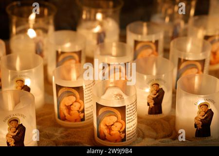 Prayer candles bearing the image of Mary, baby Jesus and Saint-Antoine on Boxing Day in the Notre-Dame de Tulle Catholic Cathedral in Corrèze. Tulle, Stock Photo