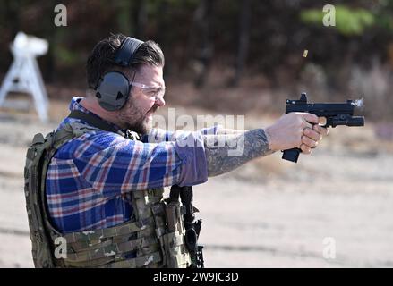 Fayetteville, United States of America. 13 December, 2023. Actor Jack Osbourne fires a pistol at a target during practice prior to participating in the 2023 Green Beret Celebrity Tactical Challenge at the U.S. Army John F. Kennedy Special Warfare Center Miller Training Complex of Fort Liberty, December 13, 2023 Fayetteville, North Carolina. Fourteen celebrities teamed up with Green Berets to take part in the annual shooting event.  Credit: K. Kassens/US Army Photo/Alamy Live News Stock Photo
