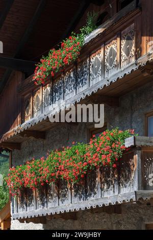 Summer flowers, geraniums (Pelargonium) on a balcony of an old house, Reit im Winkl, Upper Bavaria, Bavaria, Germany Stock Photo