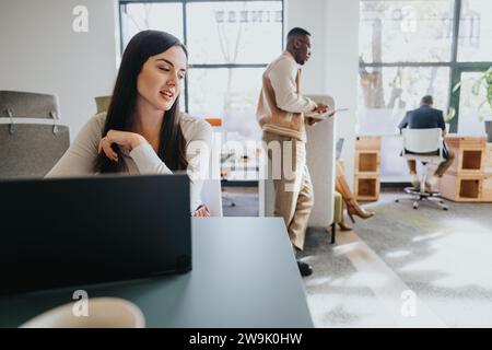 Diverse business team analyzing data and discussing market research for a new project in a corporate office. Stock Photo