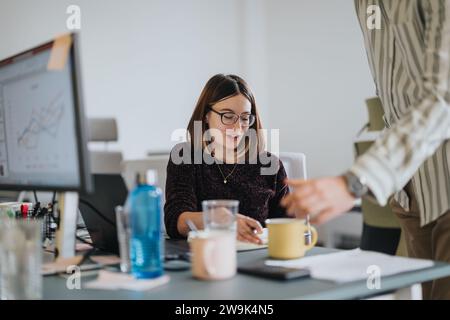 Multicultural team collaborating on market analysis and strategizing for profit growth. Stock Photo