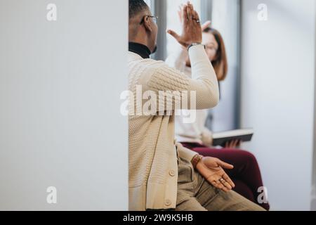 Teammates giving high five each other. Success concept. Stock Photo