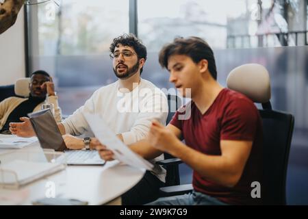 Successful business team collaborating and brainstorming in the office. Stock Photo