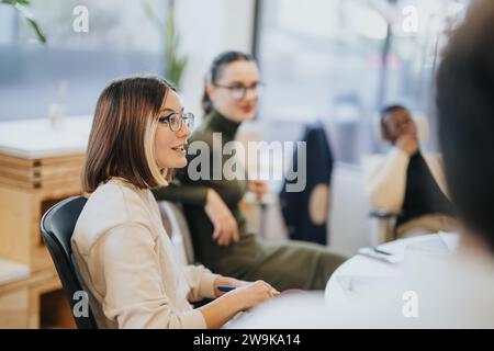 Diverse business professionals discussing statistics, brainstorming marketing strategy for profit growth in multicultural office. Stock Photo