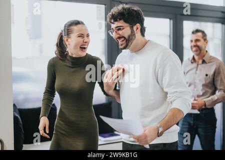 Successful collaboration of diverse employees in a corporate office and positive working atmosphere. Stock Photo
