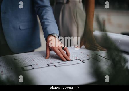 Collaborating Architects Discussing Blueprint on Construction Site Stock Photo