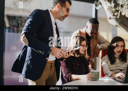 Different aged group of creative coworkers collaborating in the corporate office. Stock Photo