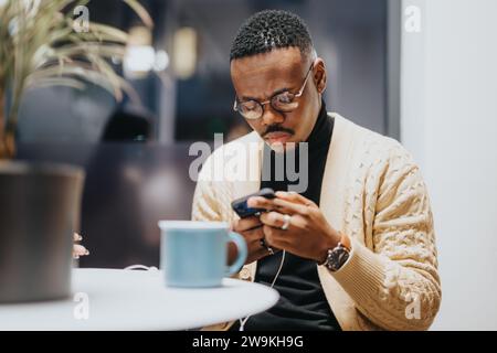 Male person watching something on the phone during late night break from work. Stock Photo